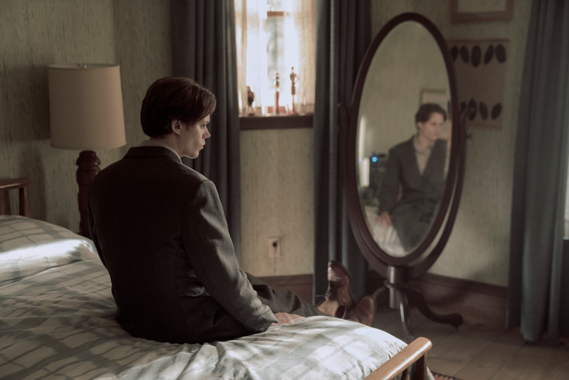 The Kid in Matthew’s suit, sitting on Matthew’s bed, looking in Matthew’s mirror.
